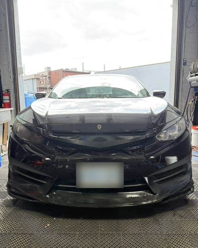 Black sedan at the studio doorway